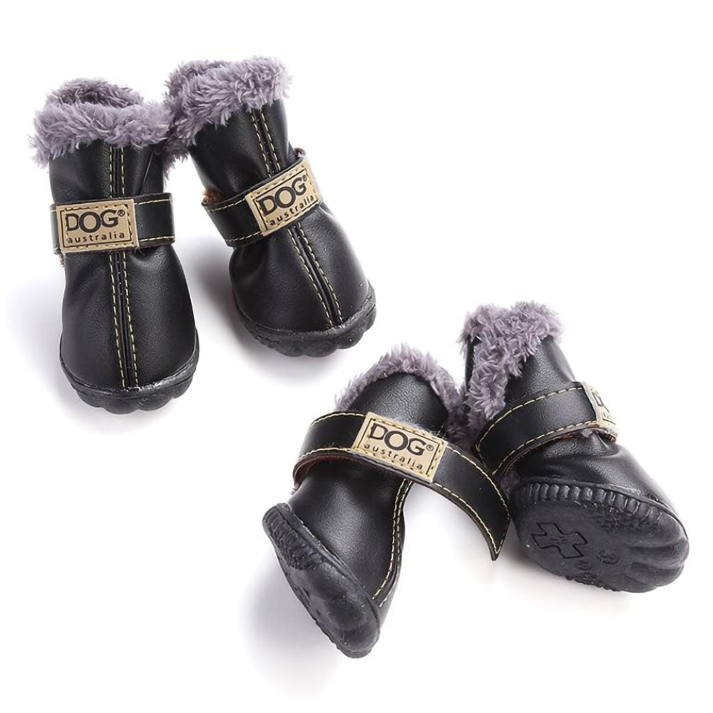 Lot of four black Pup Ugg™ - Dog Winter Shoes on a white background.