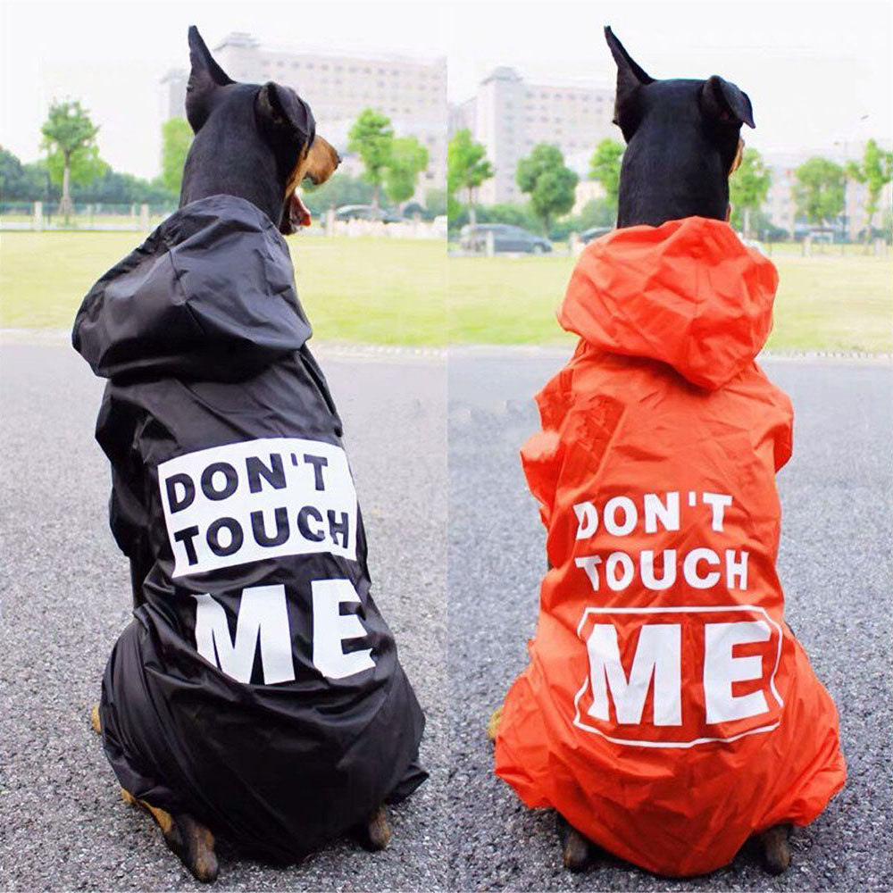 2 large black dogs in a black (on the left) and orange (on the right) Menace™ - Matching Dog & Owner Raincoat, Medium and Large Dogs with hood and legs on a vivid background.