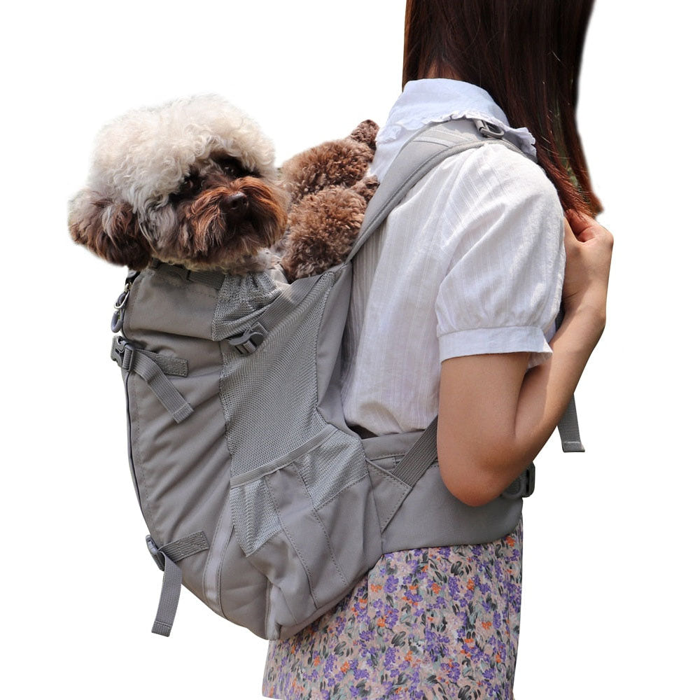 A puddle being carried on the back of a human in a gray Piggyback-Pack Pro™ - Pet Backpack Carrier on a white background. 