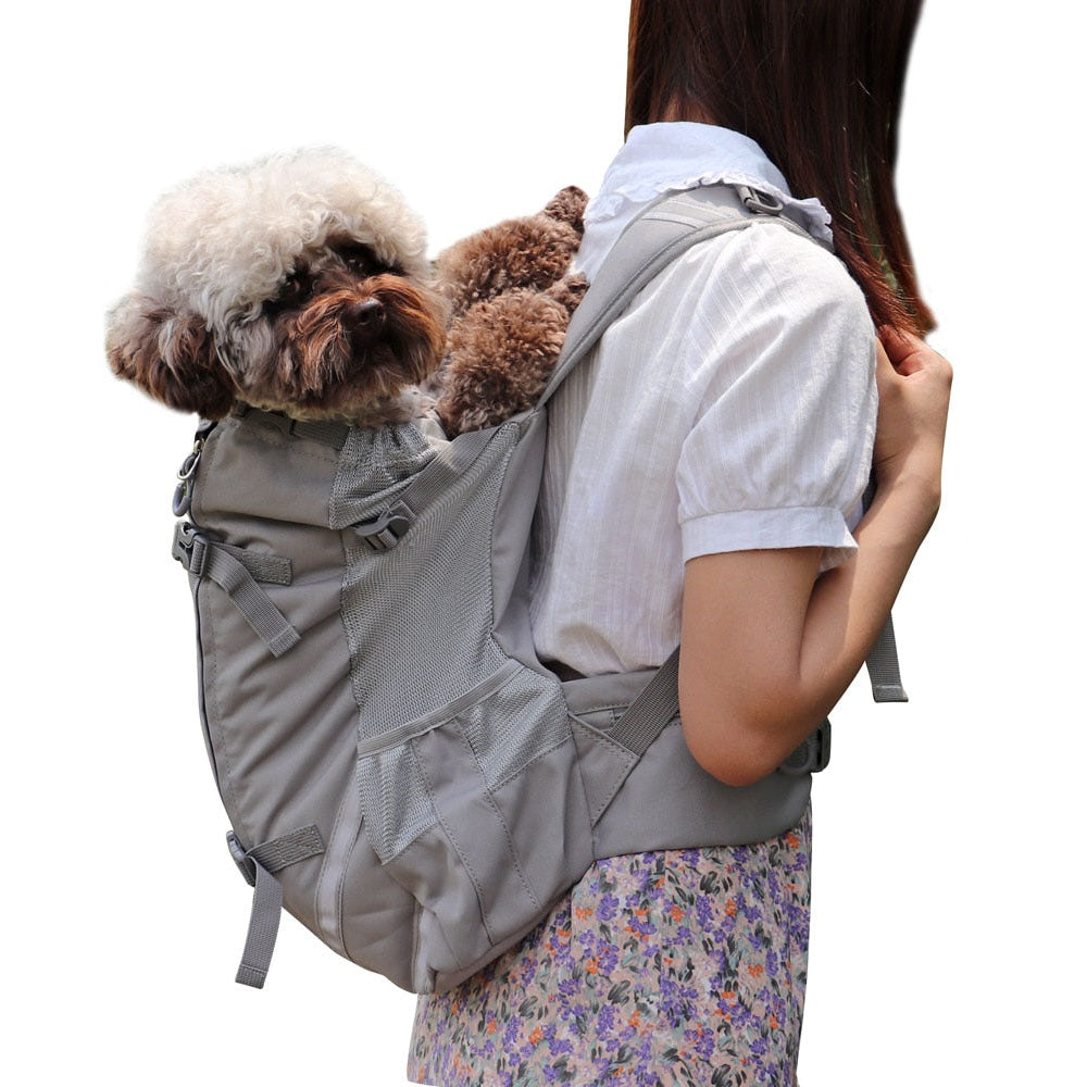 A puddle being carried on the back of a human in a gray Piggyback-Pack Pro™ - Pet Backpack Carrier on a white background.
