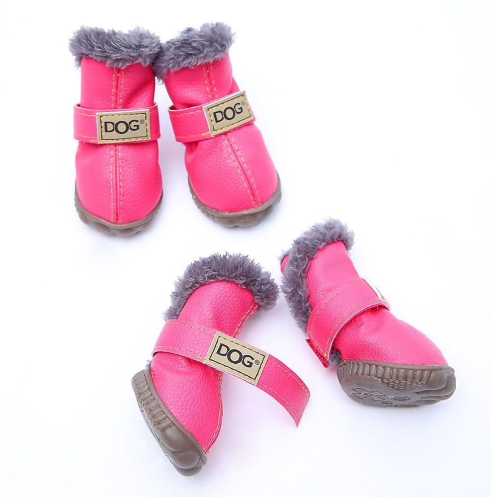 Lot of four pink Pup Ugg™ - Dog Winter Shoes on a white background. 