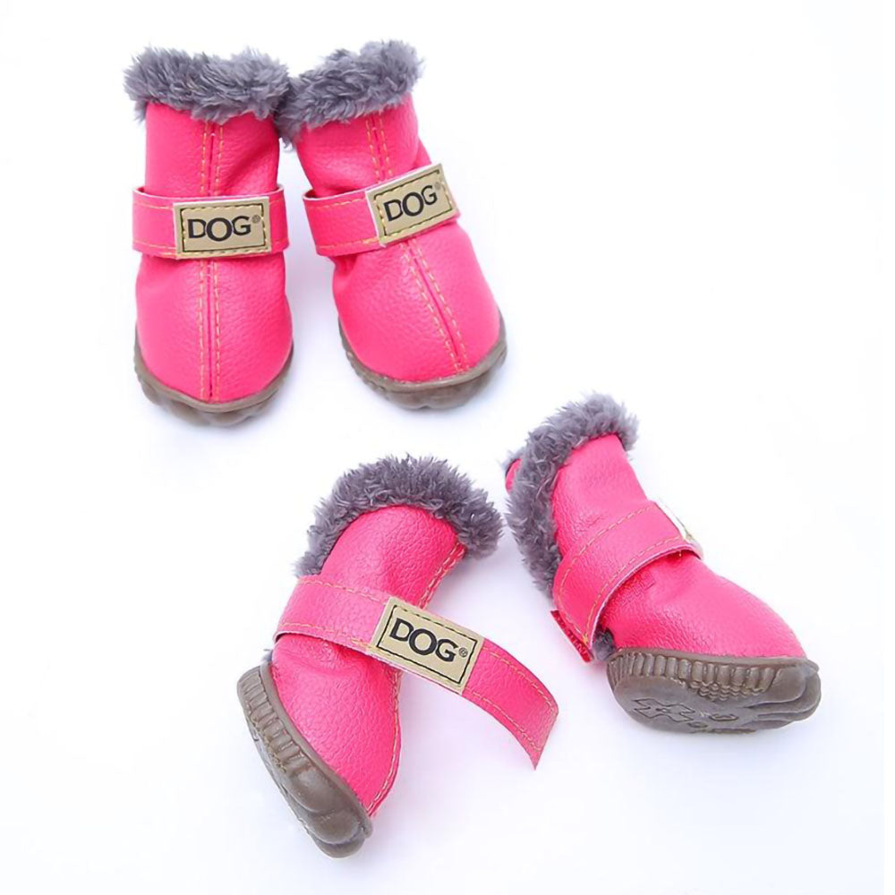 Lot of four pink Pup Ugg™ - Dog Winter Shoes on a white background.