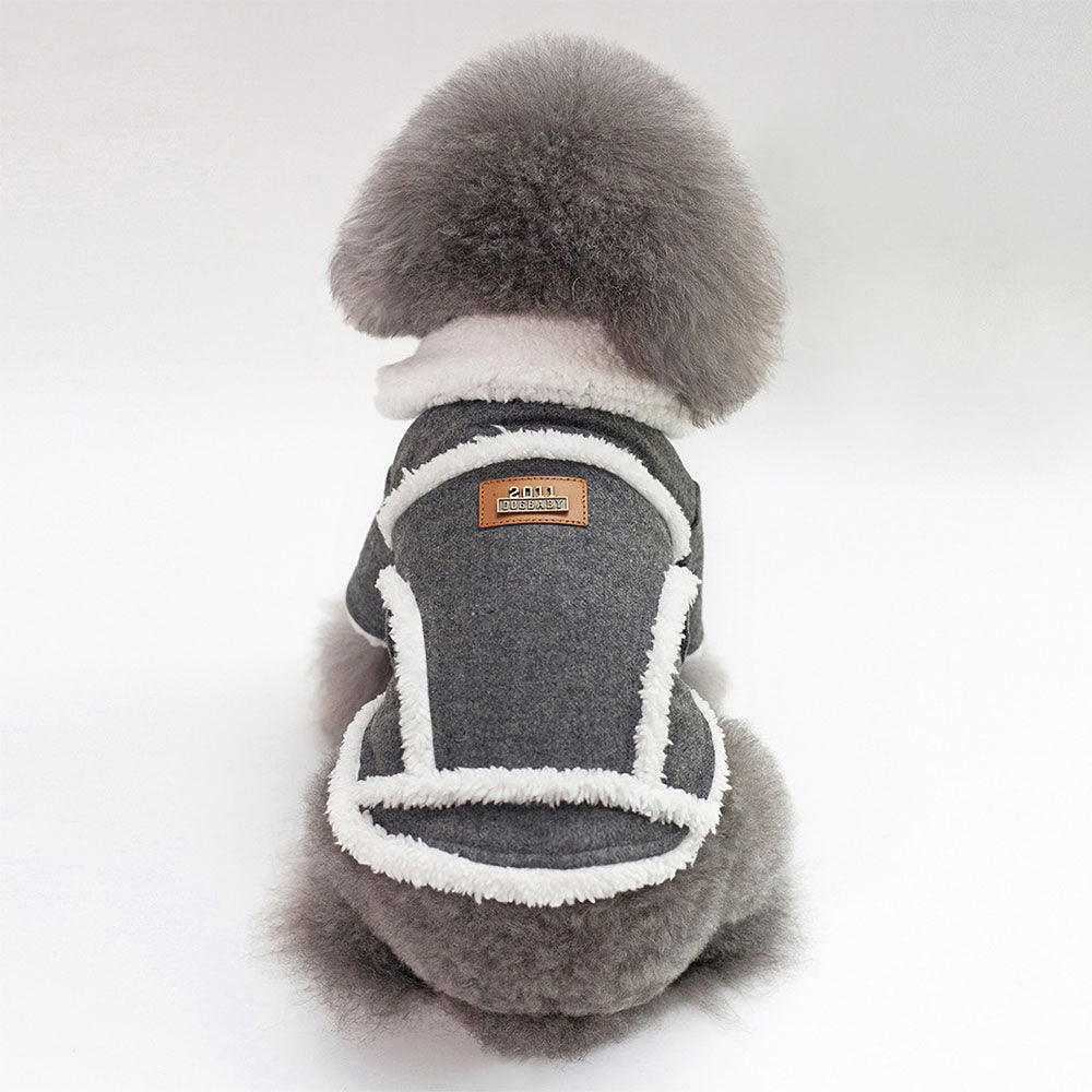 Small fluffy gray dog in a dark gray Dogbaby Snug - Dog Winter Jackets with faux fur trimmings on collar and as details around the vest on white background.