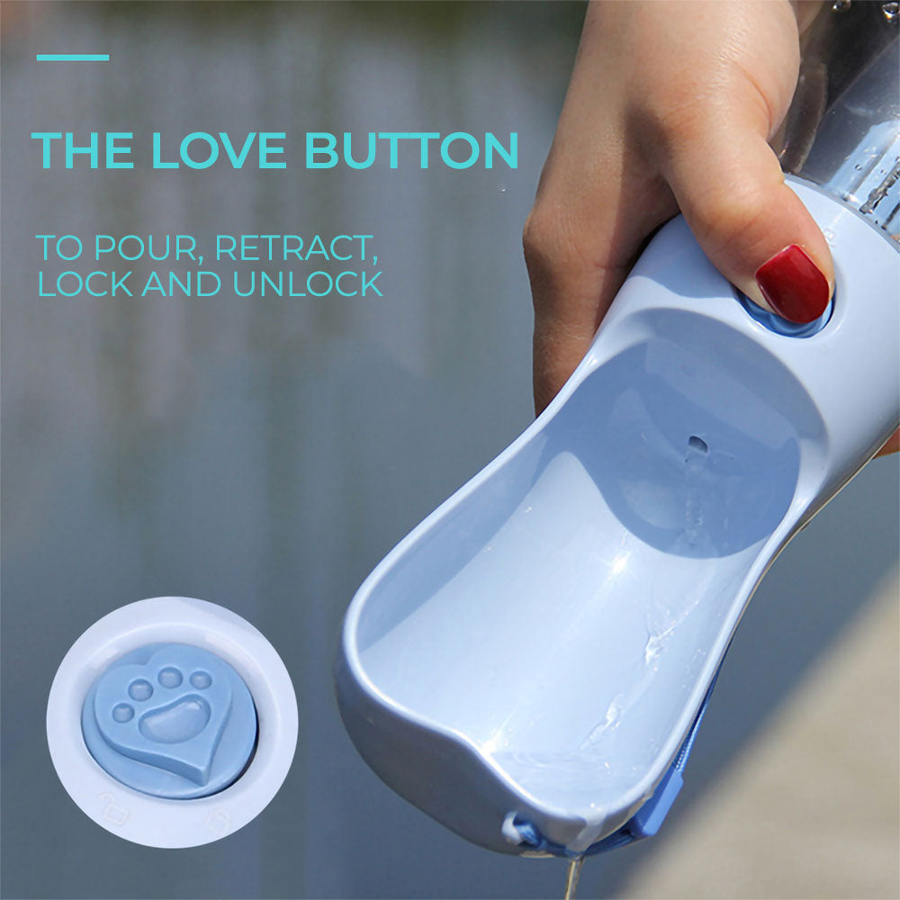Close up of a hand holding and pressing the pour love button for a blue Products Heart™ - Pet Water Bottle on a vivid background.