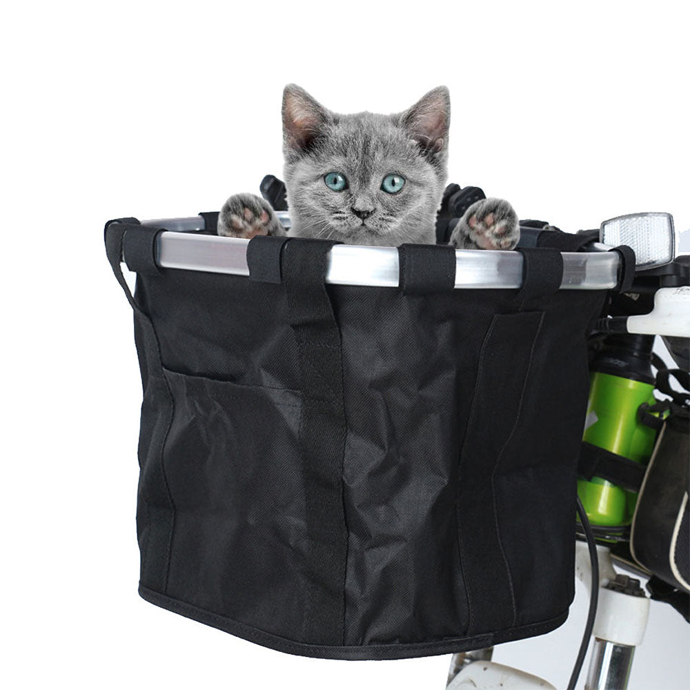 Small grey cat in a black Pawsket™ - Pet Bike Basket Carrier on a bike close up pictures on a white background. 