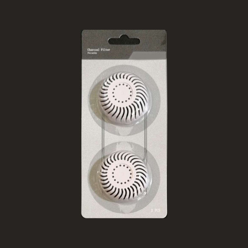 White activated charcoal filter in a two pcs package on black background