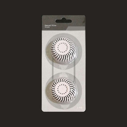 White activated charcoal filter in a two pcs package on black background